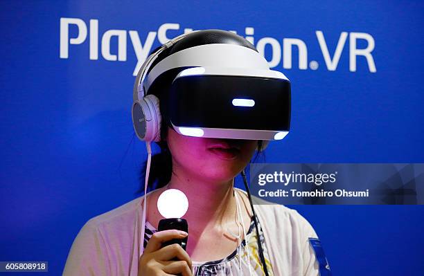 Visitor wearing a Sony Interactive Entertainment Inc. PlayStation VR headset plays a video game at the Tokyo Game Show 2016 on September 15, 2016 in...