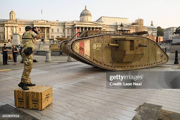 An Army photographer takes a photograph of a replica British Mark IV tank as it is displayed in Trafalgar Square on September 15, 2016 in London,...