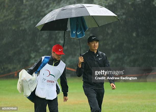 Li Haotong of China is pictured with his caddie on the tenth hole during the first round of the Italian Open at Golf Club Milano - Parco Reale di...