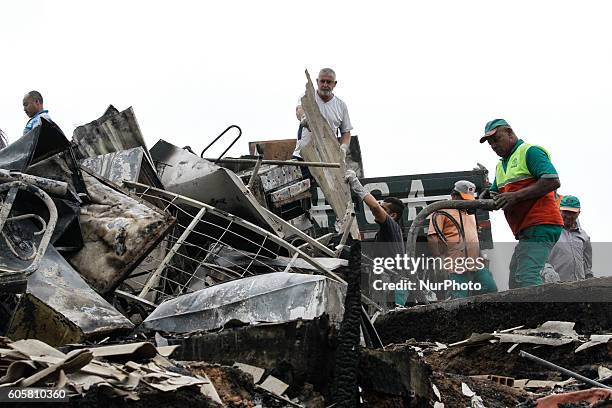 Activists and volunteers provide relief to residents this Wednesday afternoon after a fire consumed the Ocupação Esperança, a slum community on...