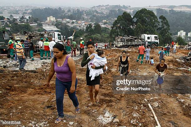 Activists and volunteers provide relief to residents this Wednesday afternoon after a fire consumed the Ocupação Esperança, a slum community on...