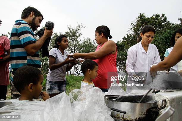 Activists and volunteers provide relief to residents this Wednesday afternoon after a fire consumed the Ocupação Esperança, a slum community on...