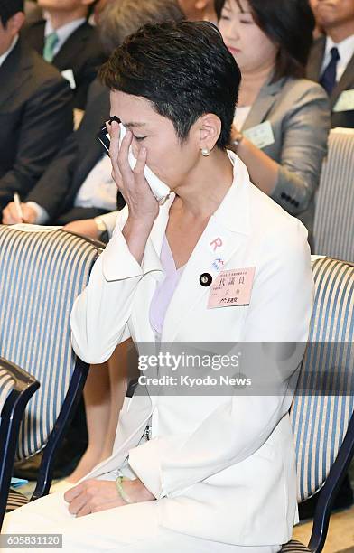 Renho covers her face with a handkerchief after being selected as the new chief of the Democratic Party at a Tokyo hotel on Sept. 15, 2016. The...