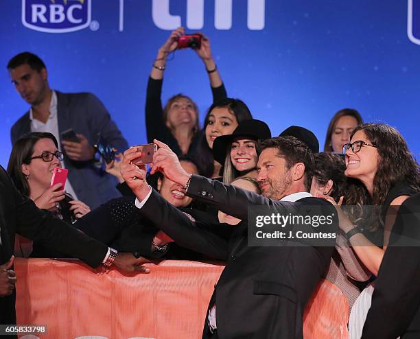 Actor Gerard Butler poses for photos with fans at the 2016 Toronto International Film Festival Premiere of "The Headhunter's Calling" at Roy Thomson...