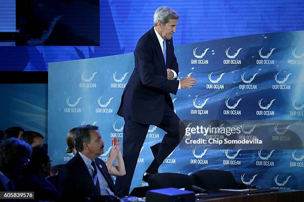 Secretary of State John Kerry takes the stage before delivering opening remarks at the Our Oceans conference at the State Department's Harry S....