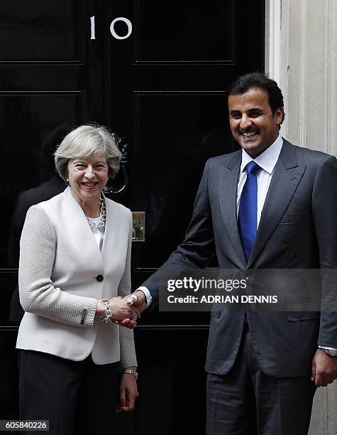 Britain's Prime Minister Theresa May , greets Qatari Emir Sheikh Tamim Bin Hamad Al Thani on the steps of 10 Downing Street in London on September 15...