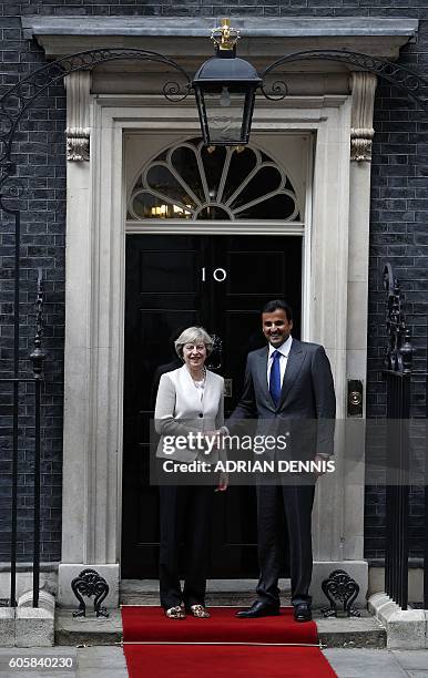 Britain's Prime Minister Theresa May , greets Qatari Emir Sheikh Tamim Bin Hamad Al Thani on the steps of 10 Downing Street in London on September 15...