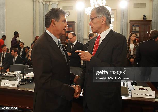 Chairman Tom Wheeler , talks with Sen. Joe Manchin , before the start of a Senate Commerce, Science and Transportation Committee hearing on Capitol...