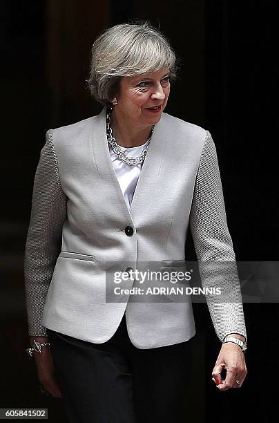 Britain's Prime Minister Theresa May exits 10 Downing Street to greet Qatari Emir Sheikh Tamim Bin Hamad Al Thani, ahead of their meeting in London...