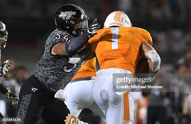 Linebacker Andrew Motuapuaka of the Virginia Tech Hokies hits running back Jalen Hurd of the Tennessee Volunteers in the second half at Bristol Motor...