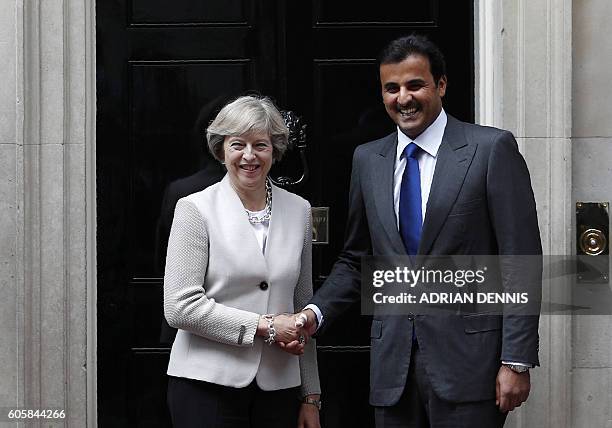 Britain's Prime Minister Theresa May , greets Qatari Emir Sheikh Tamim Bin Hamad Al Thani on the steps of 10 Downing Street in London on September 15...