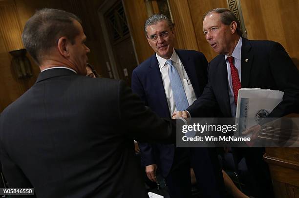 Sen. Tom Udall greets Donald Sampler Jr. , assistant to the administrator in the U.S. Agency for International Development's Office of Afghanistan...