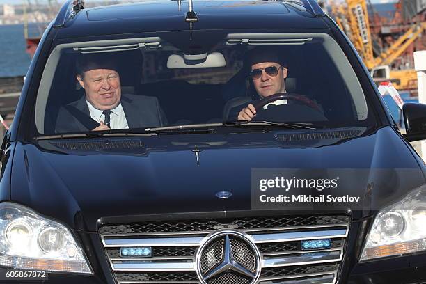 Russian Prime Minister Dmitry Medvedev and Presidential Envoy for Southern Federal District Vladimir Ustinov ride a Mercedes GL while visiting a...