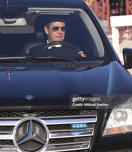 Russian Prime Minister Dmitry Medvedev drives a Mercedes GL while visiting a constructing site of the Kerch Strait Bridge, on September 15, 2016 in...