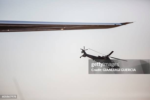 Denel Rooivalk attack helicopter manifactured by South African Denel flies by during the Africa Aerospace and Defence 2016 fair at the South African...