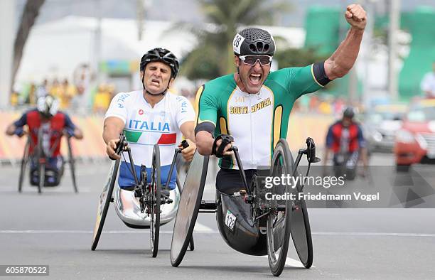 Ernst van Dyk of South Africa celebrates winning the gold medal while Alessandro Zanardi of Italy shows his dejeciton after competing in the Men's...