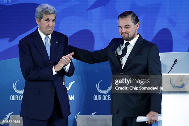 Secretary of State John Kerry and actor and environmental activist Leonardo DiCaprio leave the stage after after DiCaprio announced the launch of the...