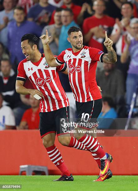 Charlie Austin of Southampton celebrates scoring his teams opener with teammate Maya Yoshida during the UEFA Europa League Group K match between...