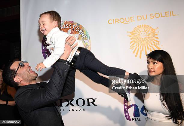 Illusionist Criss Angel tosses his son Johnny Crisstopher Sarantakos in the air as his mother Shaunyl Benson looks on at Criss Angel's HELP charity...