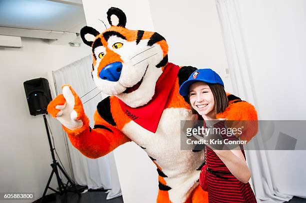 Tony The Tiger and actress Carly Gendell pose for a photo during the "Tony The Tiger" press conference debuting Tonys new look at 620 Loft & Garden...