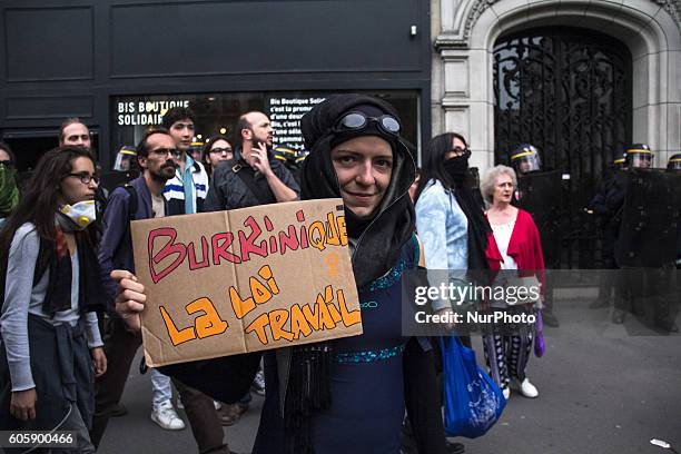 Woman protestes over the controversial Burkini issue as she protest against Labor reform law in Paris on September 15, 2016 . Parisians took out the...