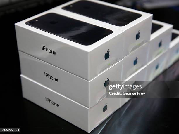 Several units of Apples new iPhone 7 sit on a table waiting to scanned into the sales system at a Best Buy store on September 15, 2016 in Orem, Utah....