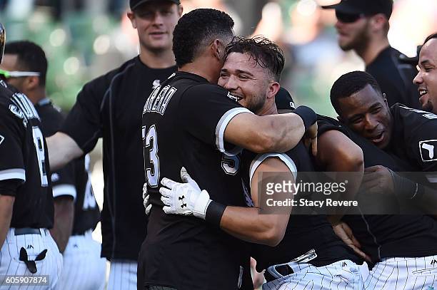 Carlos Sanchez of the Chicago White Sox is embraced by Melky Cabrera after driving in the winning run in the ninth inning of a game against the...