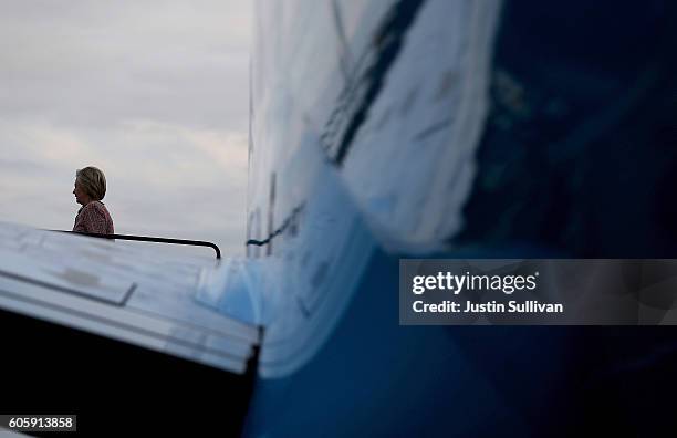 Democratic presidential nominee former Secretary of State Hillary Clinton walks off of her campaign plane at Reagan National Airport on September 15,...