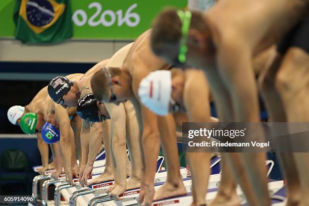 Bradley Snyder of the United States surrounded by competitors on the starting blocks at the Men's 100m Freestyle - S11 Final during day 8 of the Rio...