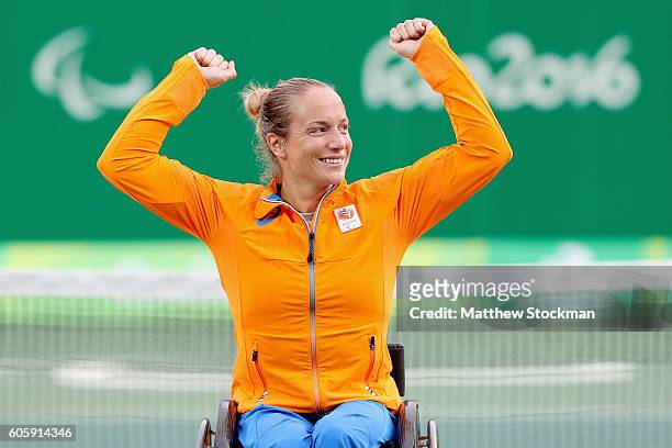 Jiske Griffioen of the Netherlands celebrates on the medals podium after defeating Aniek van Koot of the Netherlands in the women's singles gold...