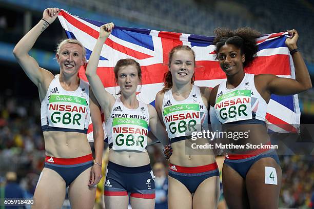 Georgina Hermitage, Sophie Hahn, Maria Lyle and Kadeena Cox of Great Britain pose for photographers after finishing second in the women's 4x100 meter...