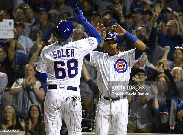 Jorge Soler of the Chicago Cubs is greeted by Addison Russell after hitting a two-run homer against the Milwaukee Brewers during the second inning on...