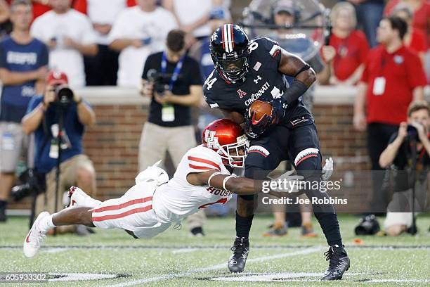 Howard Wilson of the Houston Cougars makes a tackle against Nate Cole of the Cincinnati Bearcats in the first half at Nippert Stadium on September...