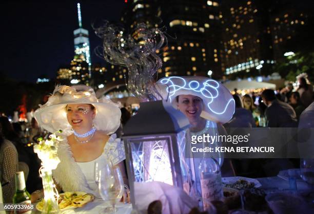People gather for the "Diner en Blanc" in Battery park New York on Septembre 15, 2016. The "Diner en Blanc" is a chic secret pop-up style picnic...