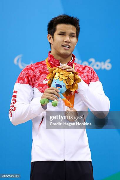 Bronze medalist Keiichi Kimura of Japan celebrates on the podium at the medal ceremony for the Men's 100m Freestyle - S11 Final during Day 8 of the...