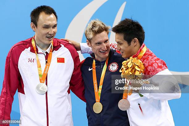 Silver medalist Bozun Yang of China, gold medalist Bradley Snyder of the United States and bronze medalist Keiichi Kimura of Japan celebrate on the...