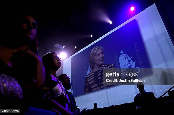 Attendees look on as democratic presidential nominee former Secretary of State Hillary Clinton speaks during the Congressional Hispanic Caucus...