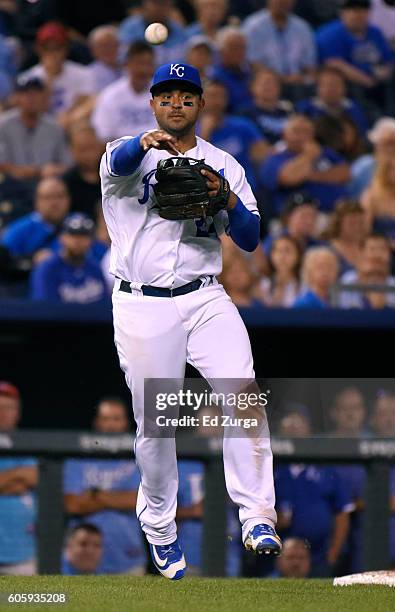 Christian Colon of the Kansas City Royals throws to first to get the out on Ryon Healy of the Oakland Athletics in the fourth inning at Kauffman...