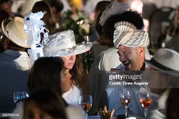 Diners sit down for dinner during the annual 'Diner en Blanc' in Battery Park City, September 15, 2016 in New York City. Diner en Blanc was launched...