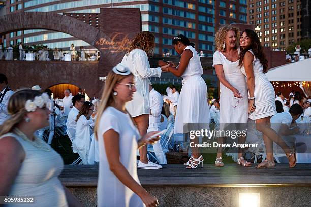 Revelers attend the annual 'Diner en Blanc' in Battery Park City, September 15, 2016 in New York City. Diner en Blanc was launched in France nearly...