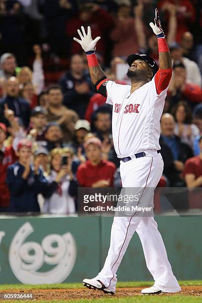 David Ortiz of the Boston Red Sox celebrates after hitting a home run against the New York Yankees during the eighth inning at Fenway Park on...