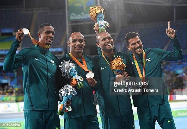 Silver medalist Felipe Gomes of Brazila and bronze medalist Daniel Silva of Brazil pose with their guides after the medal ceremony for the Men's 200m...