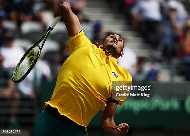 Nick Kyrgios of Australia serves with his nose plugged due to a nose bleed in his singles match against Andrej Martin of Slovakia during the Davis...