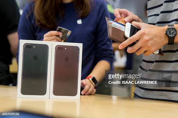 Customer buys two new Iphone 7 smartphones during the opening day of sales at an Apple store in Hong Kong on September 16, 2016. With new iPhones...