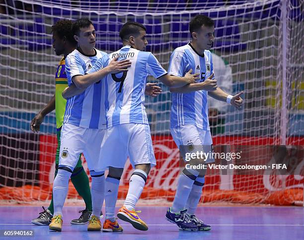 Alamiro Vaporaki, Cristian Borruto and Maximiliano Rescia of Argentina congratuate one another after Vaporaki's goal as Jeffery Bule of the Solomon...