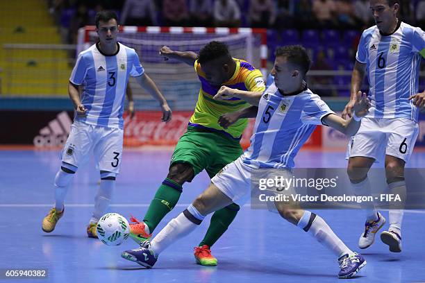 Maximiliano Rescia of Argentina blocks a shot by George Stevenson of the Solomon Islands during Group E match play between Argentina and the Solomon...