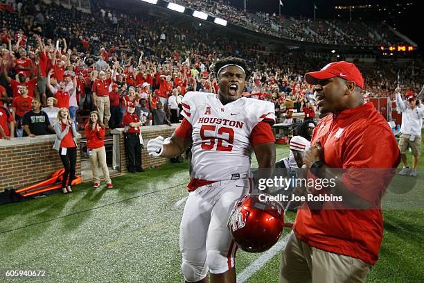 Jerard Carter of the Houston Cougars celebrates along with fans after an interception return for a touchdown by Howard Wilson in the fourth quarter...