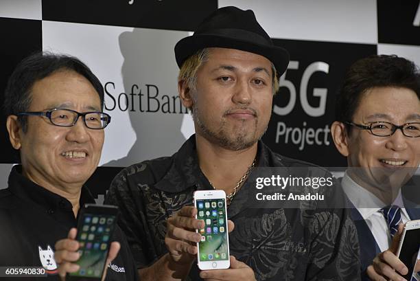 Customers inspects new iPhone models at a telecom shop in Omotesando Avenue in Tokyo, Japan on September 16, 2016. Apple has released for sale its...