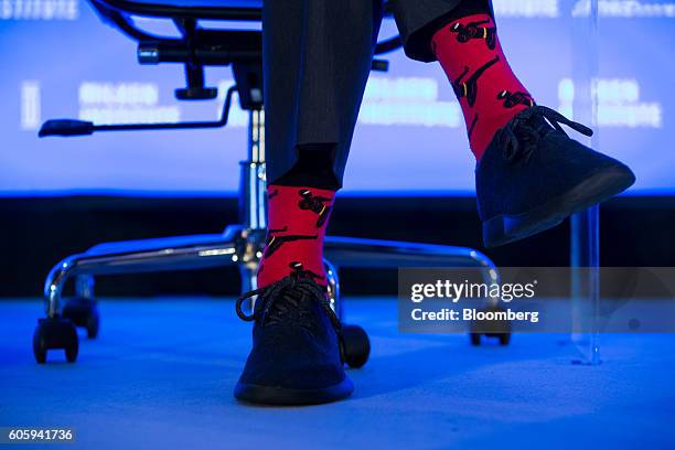 The socks of David Bonderman, co-founder and chairman of TPG Holdings LP, are seen as he speaks at the Milken Institute Asia Summit in Singapore, on...