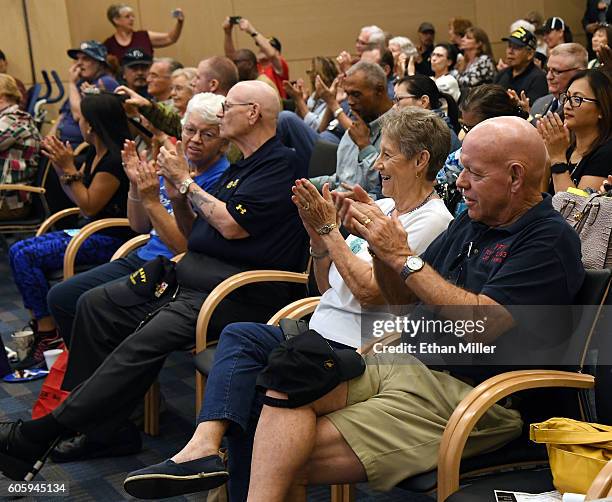 Group of veterans including Fred L. Herr and his wife Peggy Herr react during a performance by recording artist John Fogerty and Six-String Soldiers,...